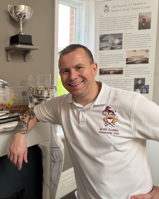 Darren Long in the club room, beside the trophies on the mantelpiece