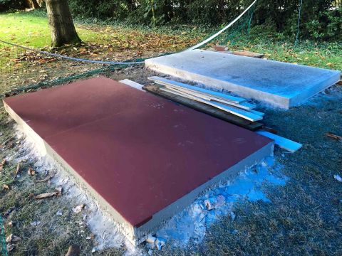 A test slab with a red polished surface on the lawn