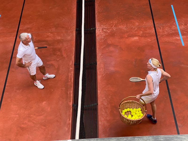 Players testing the restored court floor with a basket of balls