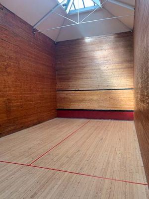 Looking down the squash tennis court to the front wall