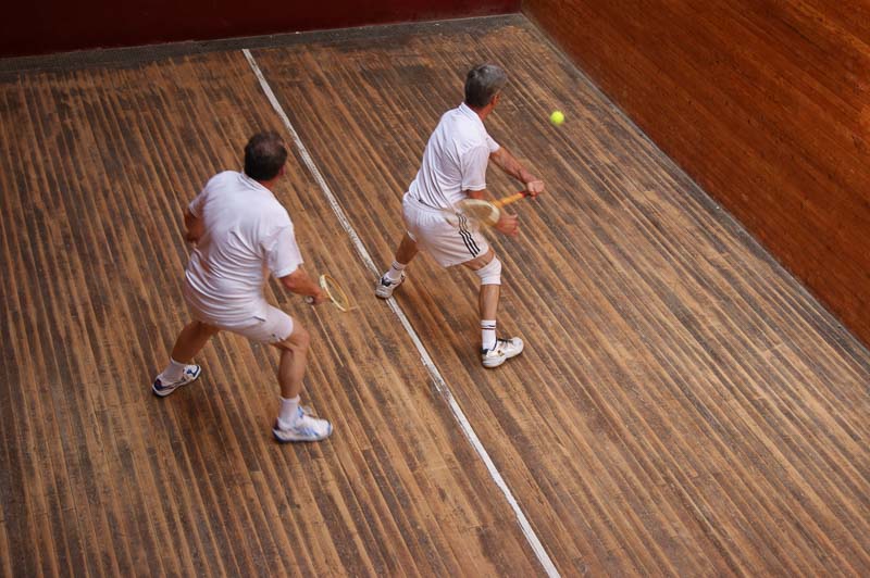 Two players in a rally in the squash tennis court